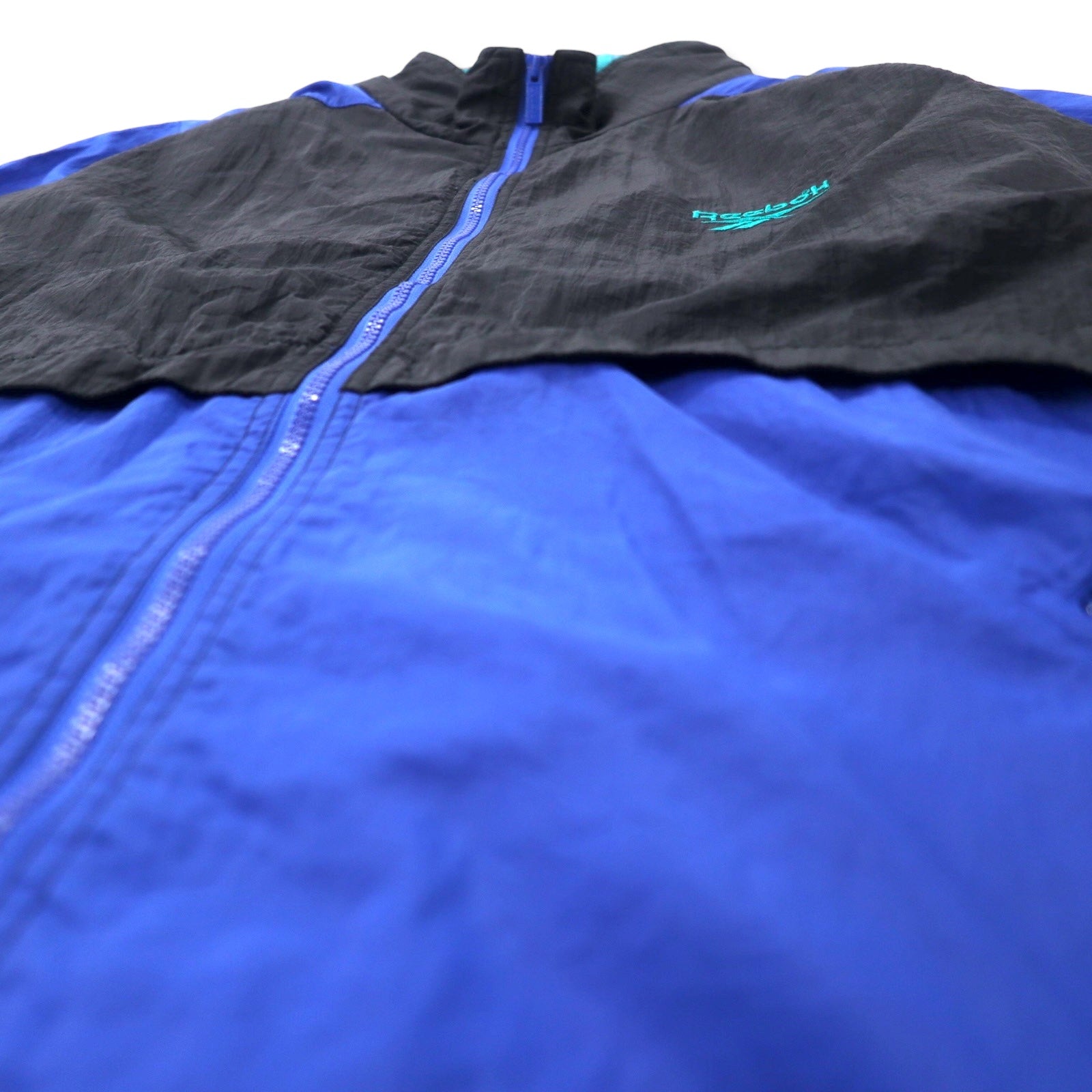 Reebok giacca in nylon anni '90, taglia XL, nero e blu, logo vettoriale, cappuccio ripiegabile