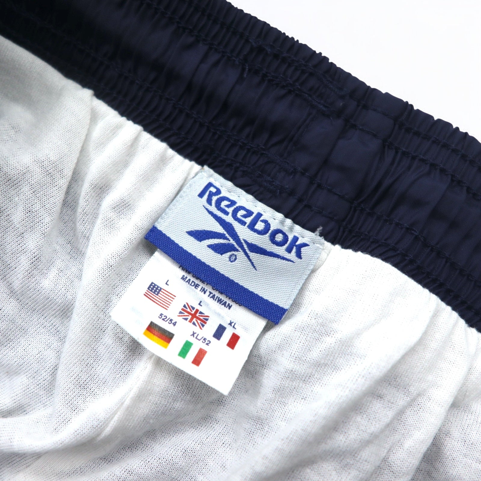 Reebok Anni '90 Pantaloni della tuta in nylon Tuta L Blu navy Logo Vector ricamato Spacco Cerniera sull'orlo