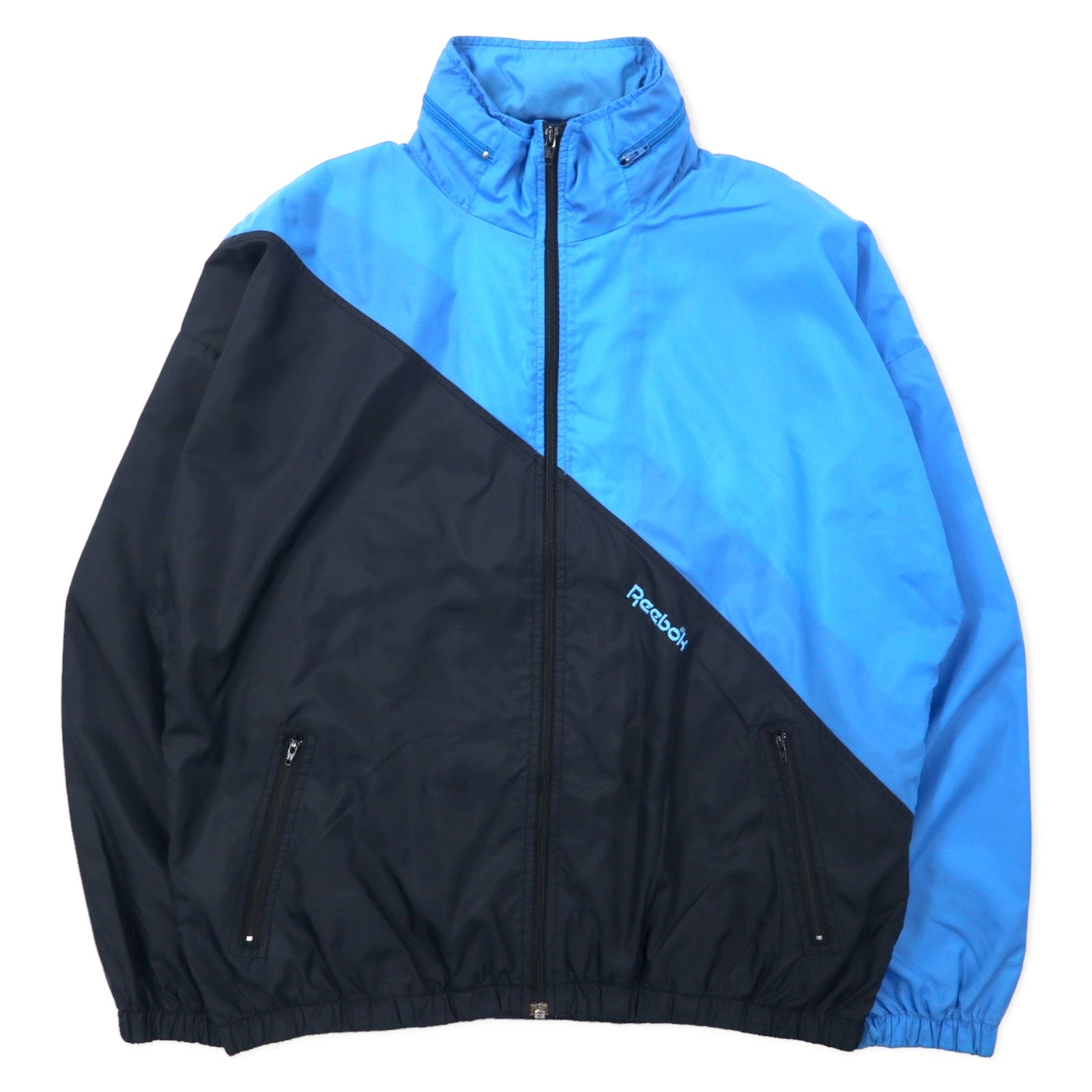 Reebok SPORT Giacca in nylon anni '90, taglia M, blu e nera, cappuccio ripiegabile, logo ricamato sul retro