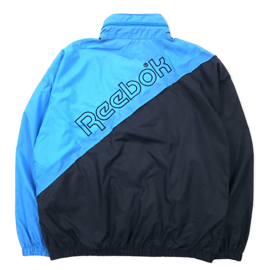 Reebok SPORT Giacca in nylon anni '90, taglia M, blu e nera, cappuccio ripiegabile, logo ricamato sul retro