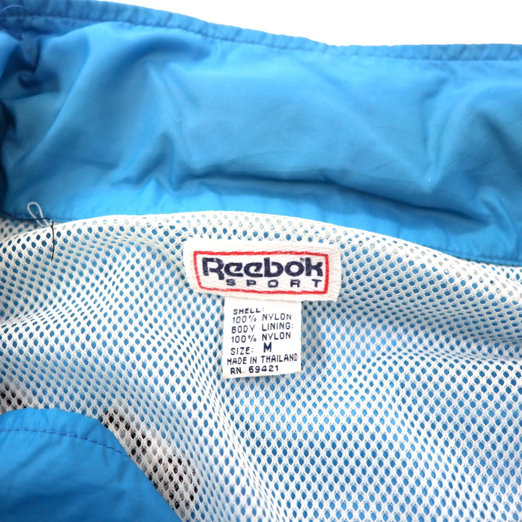 Reebok SPORT Giacca in nylon anni '90, taglia M, blu e nera, cappuccio ripiegabile, logo ricamato sul retro