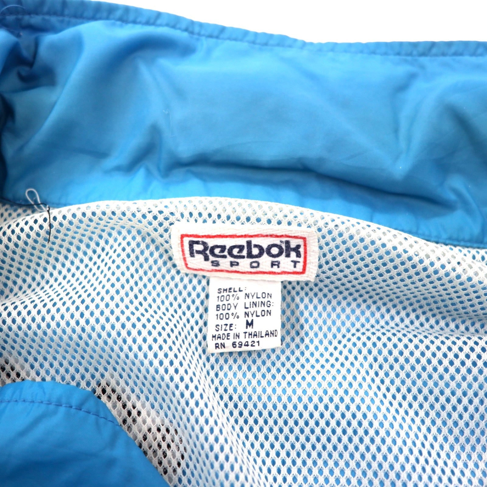 Reebok SPORT Giacca in nylon anni '90, taglia M, blu e nera, cappuccio ripiegabile, logo ricamato sul retro